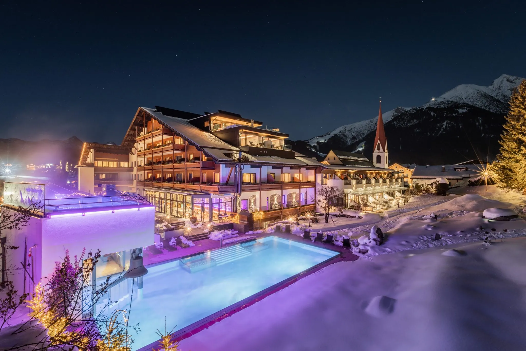 Dampfender Außenpool des Hotel Klosterbräu im Winter, Bergpanorama
